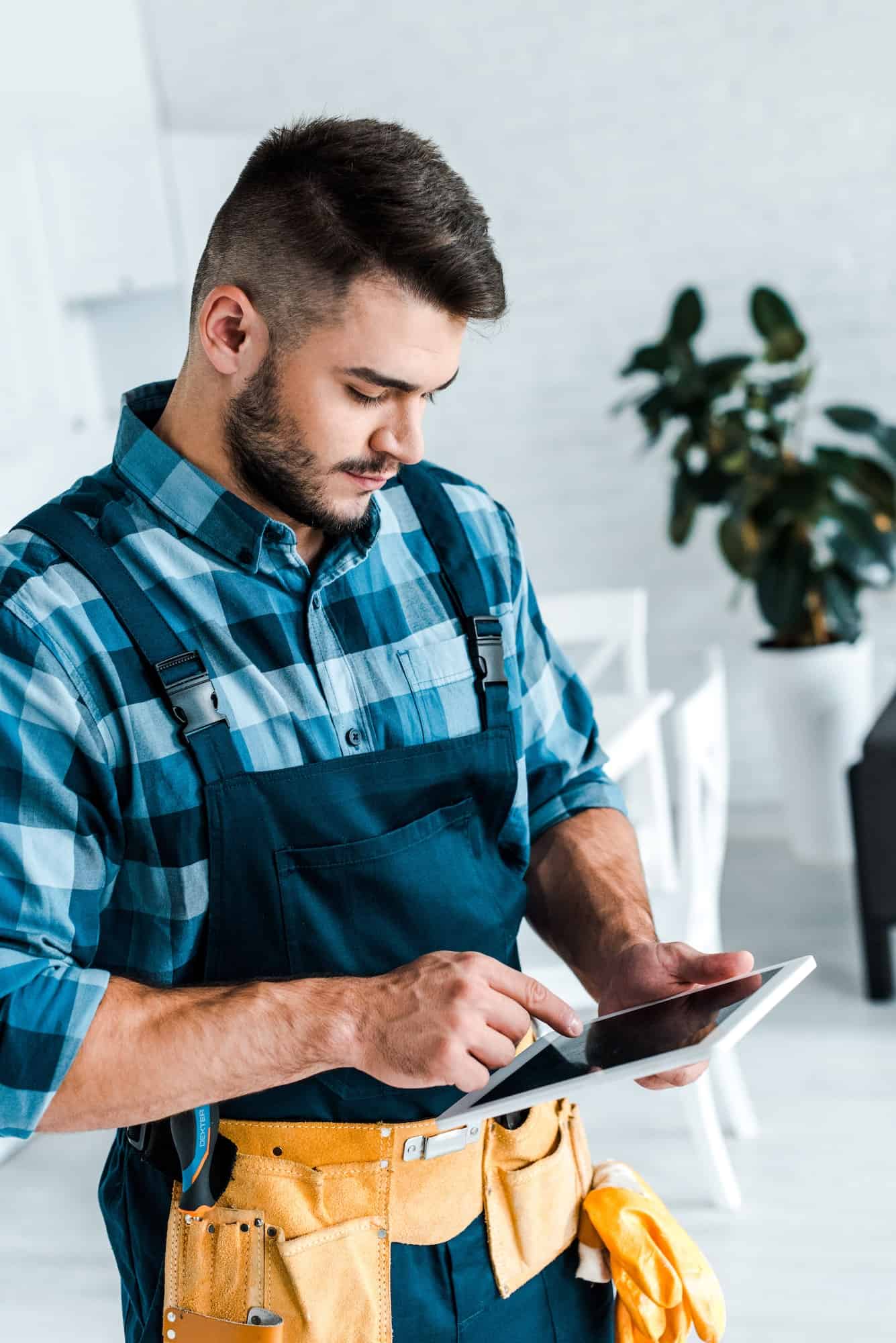 bearded-handyman-pointing-with-finger-at-digital-tablet.jpg